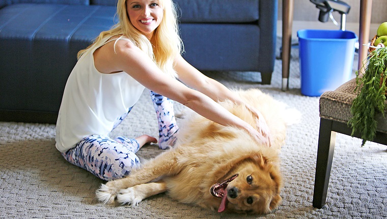 Happy girl playing with dog.