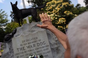 HARTSDALE, NY - JUNE 10: Doloris Speyer pays respects during an annual memorial service for military working dogs at the Hartsdale Pet Cemetery on June 10, 2012 in Hartsdale, New York. Thousands of dogs have served in American military conflicts since World War I, most recently in Afghanistan detecting roadside bombs and mines meant for U.S. troops. The cemetery, established in 1896, is the oldest pet cemetery in the United States and serves as the final resting place for tens of thousands of animals. (Photo by John Moore/Getty Images)