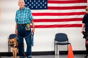 Michael Kidd, and his service dog Millie wait for their training at the Paws of War office in Nesconset, Long Island, New York on June 10, 2019. - The service dogs are either trained or being trained to help veterans through difficult times by Paws of War, an association funded entirely by private donations that provides the shelter animals free of charge.