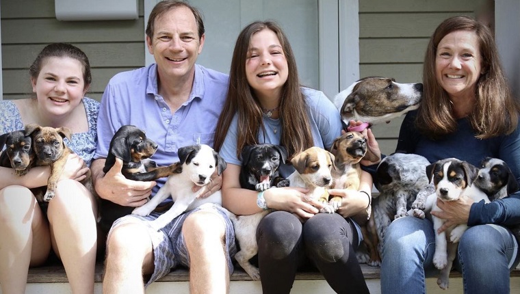 Truskowski family holding puppies with Nellie