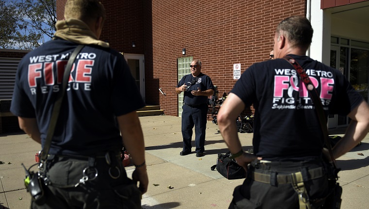 WHEAT RIDGE, CO - OCTOBER 26: Todd Rosenberger, Captain of engine 16 West Metro Fire and Rescue (center) talking to firefighters during training at Highland West Community Senior Citizens Apartments October 26, 2018 in Wheat Ridge, Colorado.