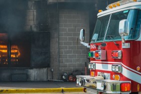 Fire and smoke at a burn building with a fire truck in front