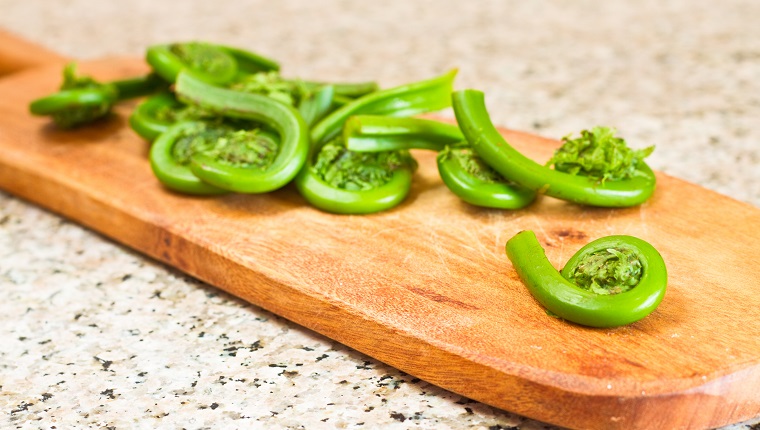 Fiddlehead Ferns On An Old Cutting Board