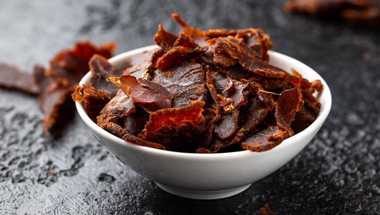 Dried Beef Jerky snack in white bowl.