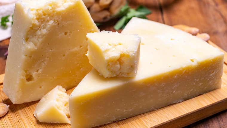 Pieces of matured pecorino romano italian cheese made from sheep milk in Lazio, Sardinia or Tuscany close up