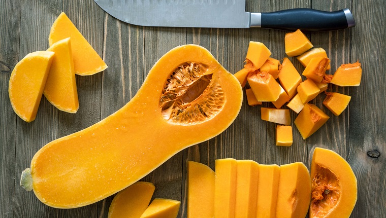 Butternut squash on a rustic wooden surface.