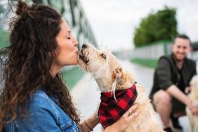 dog owner kissing her dog cities with best dog owners