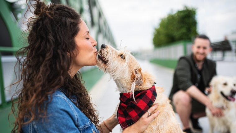 dog owner kissing her dog cities with best dog owners