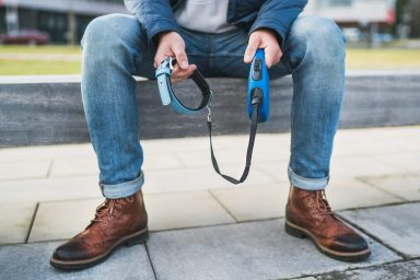 man holding empty dog leash and collar after adoption application rejected