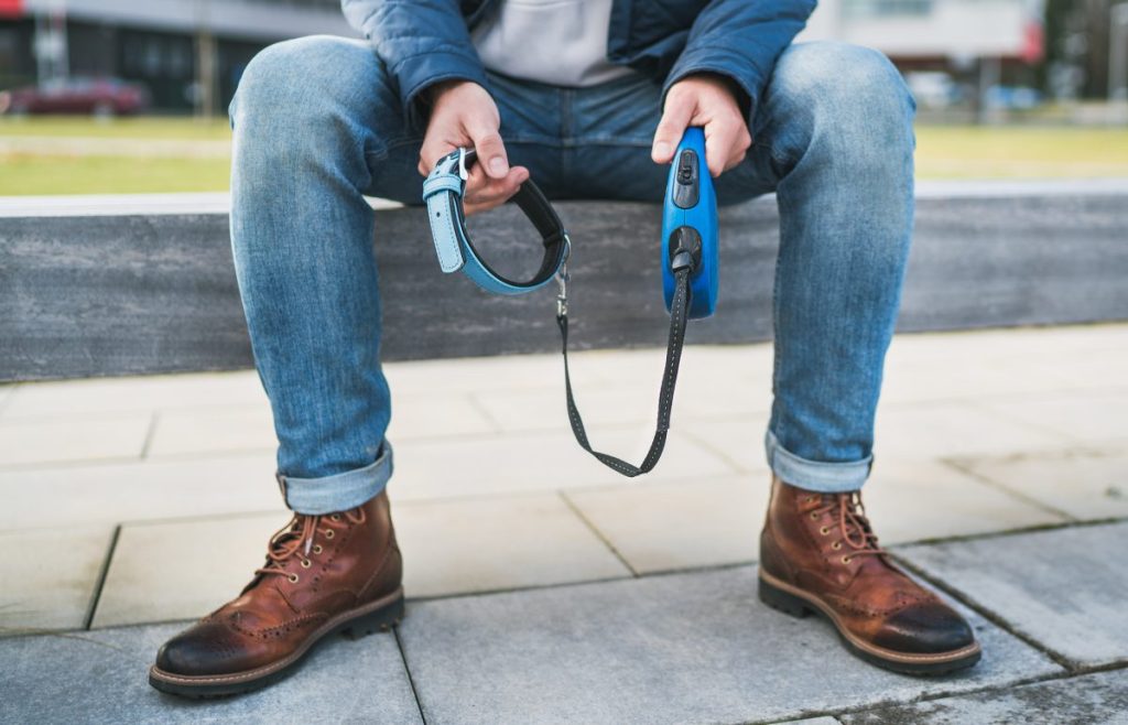 man holding empty dog leash and collar after adoption application rejected