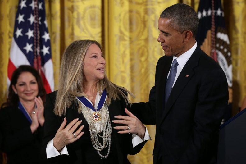 WASHINGTON, DC - NOVEMBER 2015: U.S. President Barack Obama (R) presents the Presidential Medal of Freedom to singer Barbra Streisand (L) during an East Room ceremony at the White House in Washington, D.C. when Streisand brought her dog with her. (Photo by Alex Wong/Getty Images)