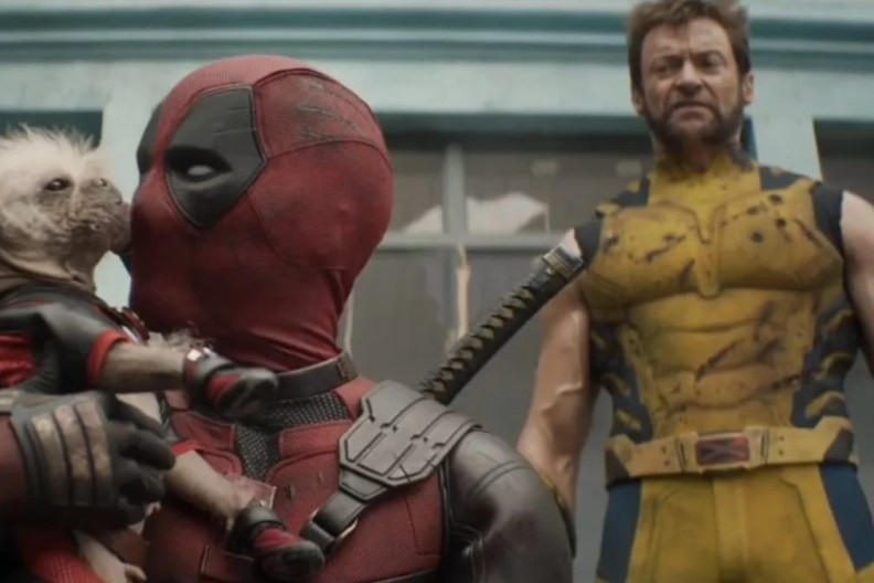 Deadpool holding “Dogpool” with Wolverine standing behind him.