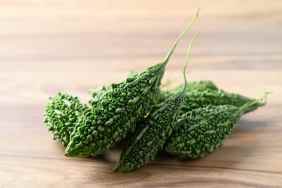 Bitter gourd or bitter melon on wooden background.