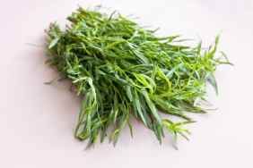 Green fresh herb tarragon on table.
