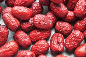 A closeup on ripe red jujube fruit, which dogs can eat safely without the seeds.